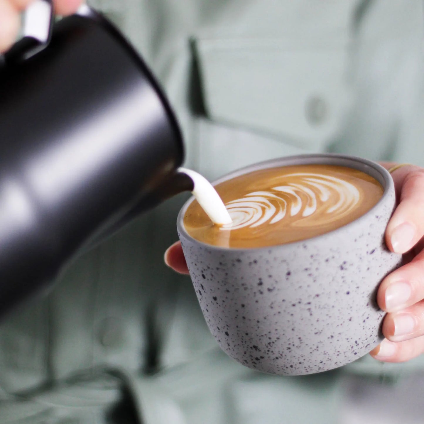 Melk opschuim kan roestvast staal zwart 350ml voor de koffieliefhebber van cappuccino en latte art. Debaristashop en Geertjandebaristaman. Sfeerbeeld.