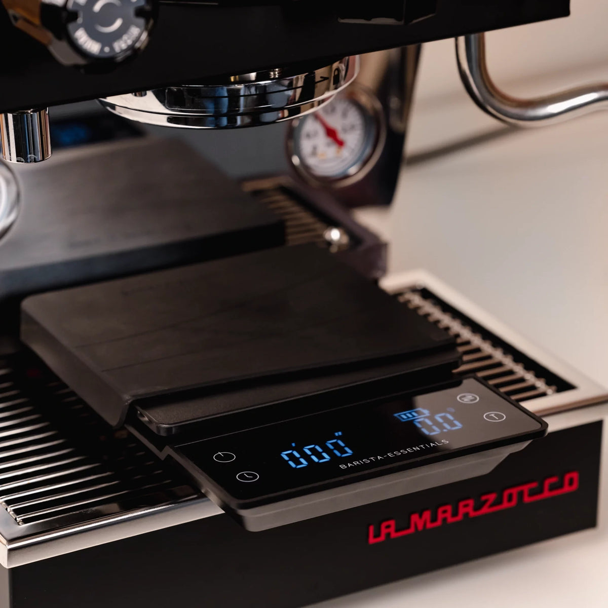 Koffieweegschaal onder de portafilteruitloop van een espressomachine
