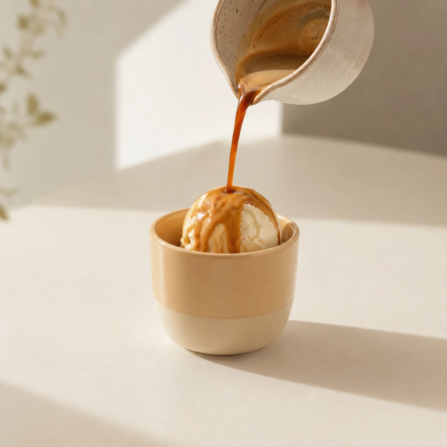 Vanille affogato maken met een bol vanille-ijs, verse espresso en Torani vanille koffiesiroop in een keramisch cappuccinokopje.